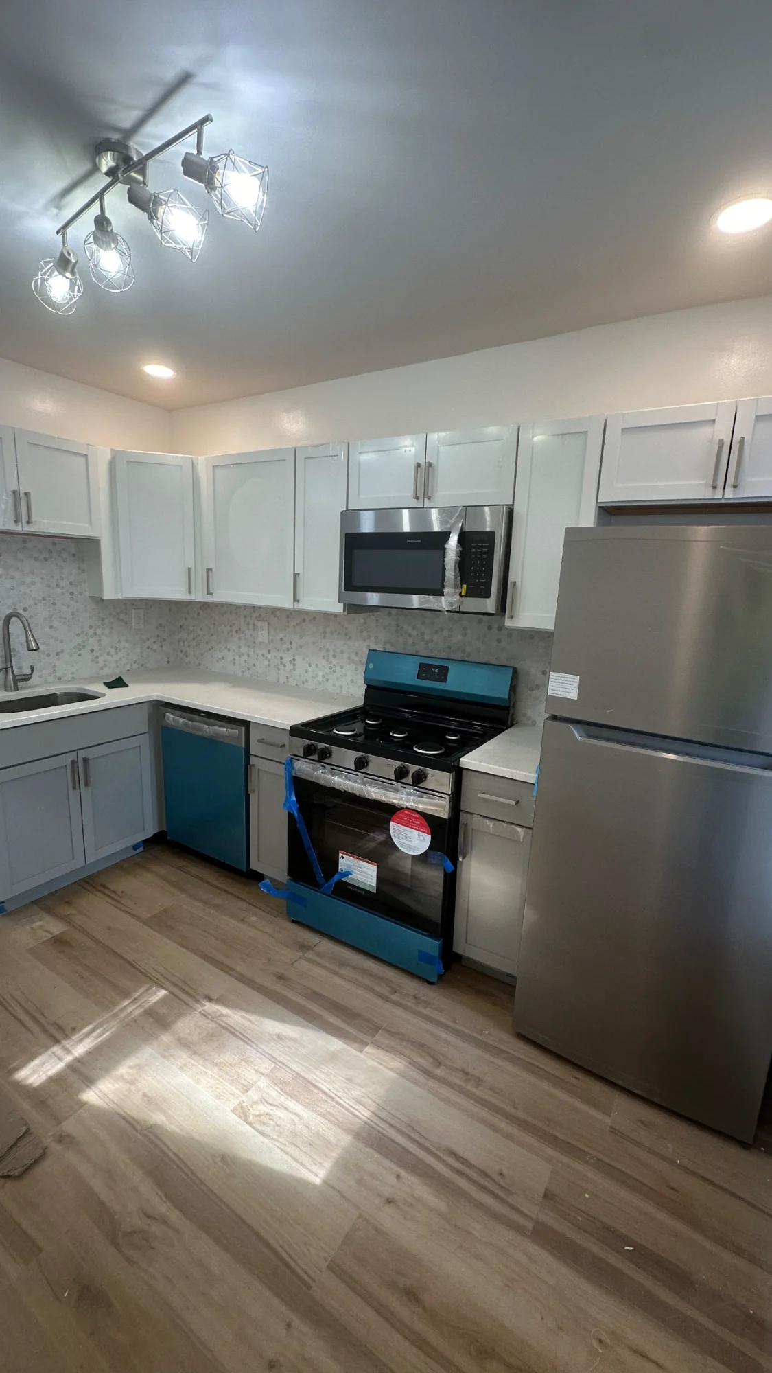 Modern kitchen remodel in Delaware County - white cabinets, granite countertops, stainless steel appliances